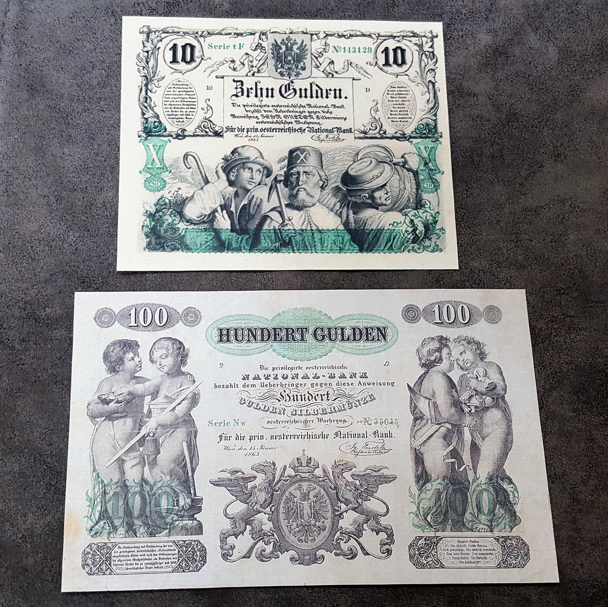 Obverse presentation of the Austria 1863 series 10 Gulden and 100 Gulden chartered banknotes, showcasing highly advanced anti-counterfeiting security lathe work, allegorical vignettes, and clean line stamp fonts.