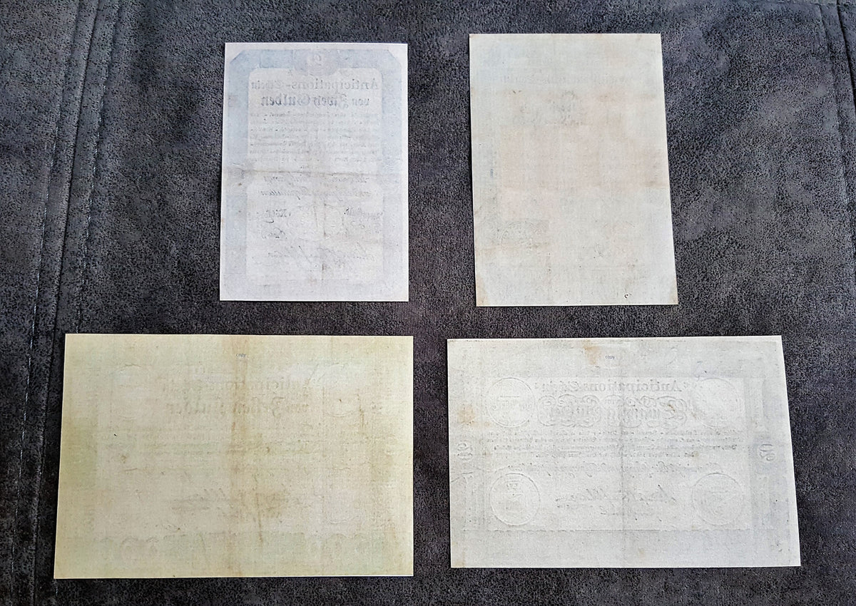 Obverse presentation of the 1813 Austrian Empire 10 Gulden and 20 Gulden currency certificates. Displays detailed geometric security borders, official imperial eagle crest seals, and deep intaglio design contrast.