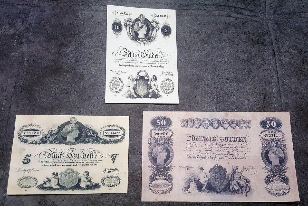 Obverse view of the prestigious Austria 1841 series 50 Gulden and 100 Gulden paper currency varieties. Showcases advanced anti-counterfeiting security lathe work, elaborate corner denomination frames, and prominent treasury stamps.