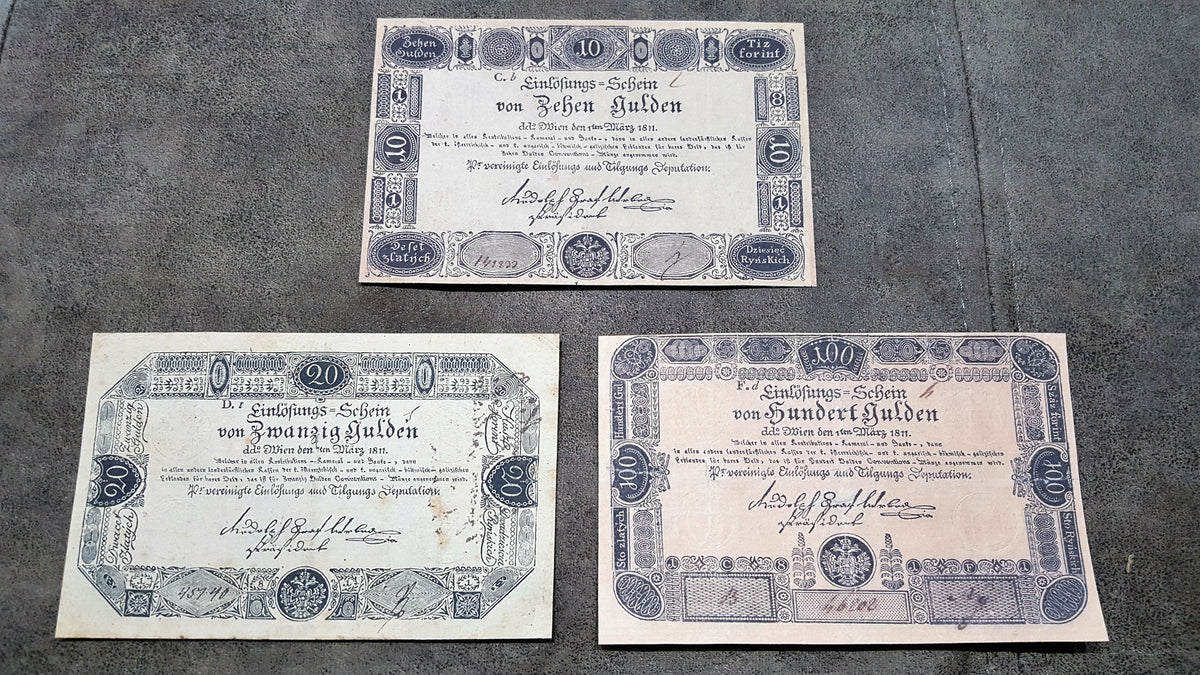 Obverse presentation of the 1811 series Austria Gulden treasury notes. Exhibits intricate early Austrian empire calligraphic scripts, traditional security border lathe work, and official financial signature blocks.