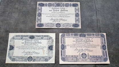 Obverse presentation of the 1811 series Austria Gulden treasury notes. Exhibits intricate early Austrian empire calligraphic scripts, traditional security border lathe work, and official financial signature blocks.