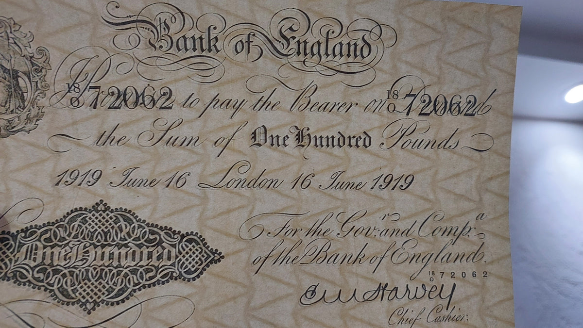 Single-note close-up highlighting copperplate typography, Britannia vignette, and E. M. Harvey Chief Cashier signature on the ultra-rare £1000 London note