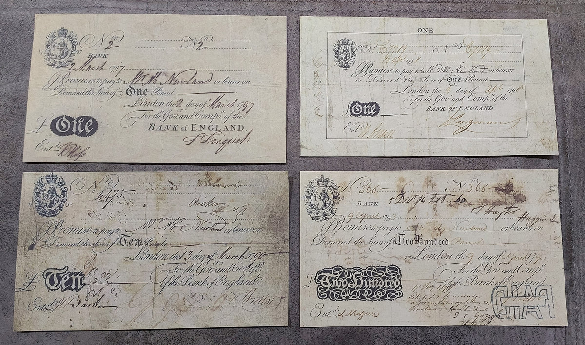Obverse view of late 1790s Bank of England promissory notes, including early 1797 and 1798 1 Pound denominations. Displays crisp copperplate calligraphy scripts, distinct legal tender promise clauses, and the legendary seated Britannia vignette highly sought after by world banknote collectors.