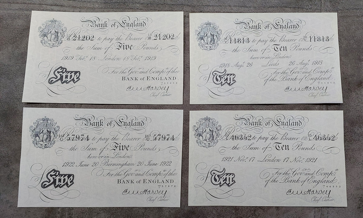 Four-note grid layout (quartet) featuring front/obverse views of the £5 (London 1919, Birmingham 1922) and £10 (Leeds 1918, London 1921) notes signed by Chief Cashier E. M. Harvey.