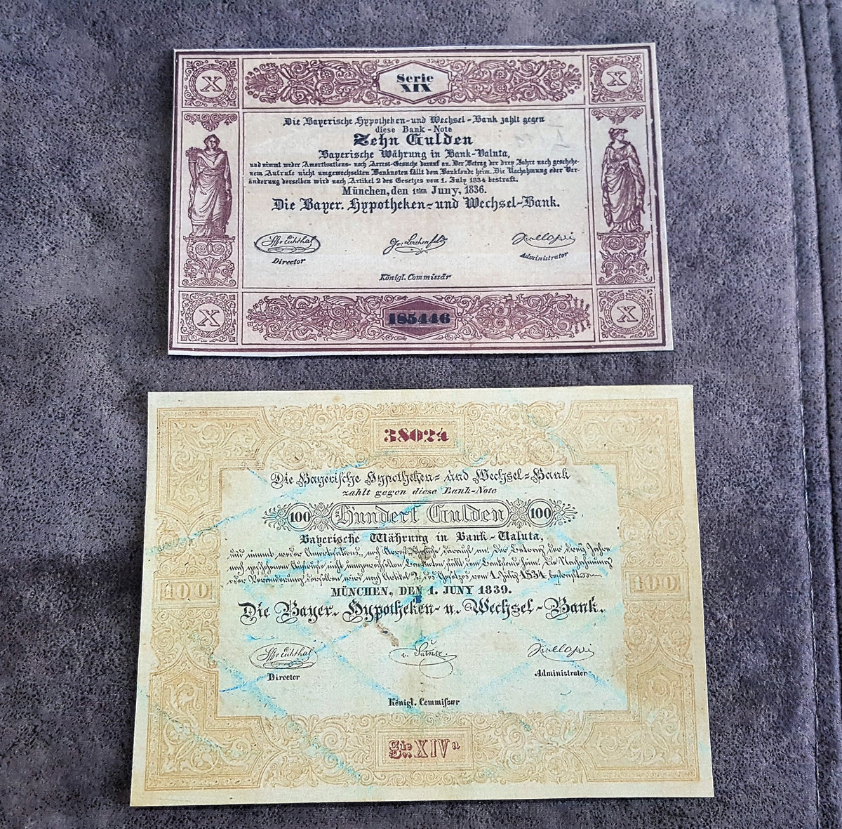 Historical German States paper money issued by Die Reichs-Hypotheken-und-Wechsel-Bank in Munich, Bavaria, featuring 10 Gulden ("Zehn Gulden") and 100 Gulden ("Einhundert Gulden") notes with ornamental borders and official signatures.