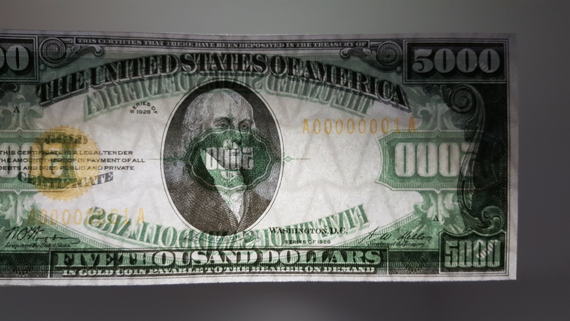 Close-up detailed view of 1928 5000 Dollar Gold Certificate showing Salmon P Chase portrait and security paper texture