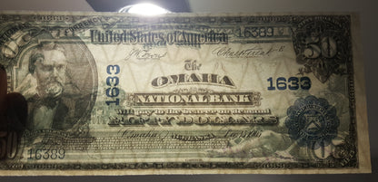 Close-up view of US National Bank Note security paper texture and watermark quality under light