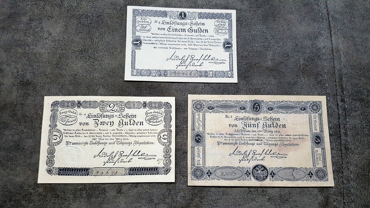 Obverse layout of the 1811 Austria issue Gulden Banco-Zettel banknotes. Features historic imperial era monochrome copperplate typography, ornate imperial crests, and distinct early central bank validation stamps.